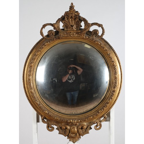 159 - A 19TH CENTURY GILTWOOD AND GESSO CONVEX MIRROR the beaded moulded frame with foliate and shell cres... 