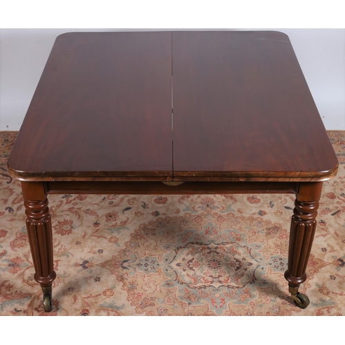 32 - A REGENCY MAHOGANY DRAW LEAF DINING TABLE of rectangular outline with rounded ends and two loose lea... 