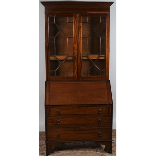 10 - A VINTAGE MAHOGANY BUREAU BOOKCASE the moulded cornice above a pair of astragal glazed doors contain... 