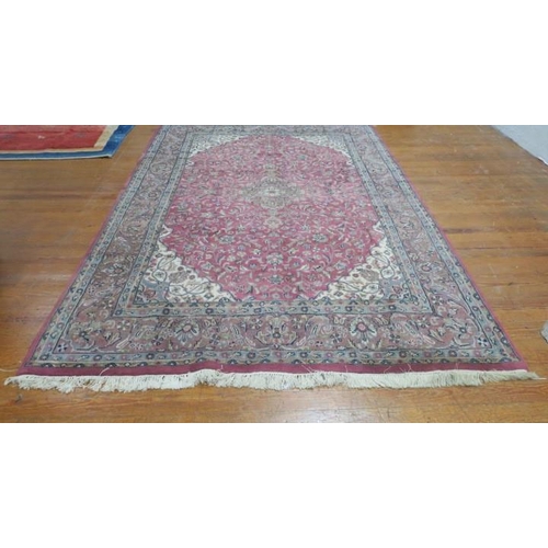 14 - A LICIAN WOOL RUG the light pink ground with central border filled with flowerheads and foliage with... 
