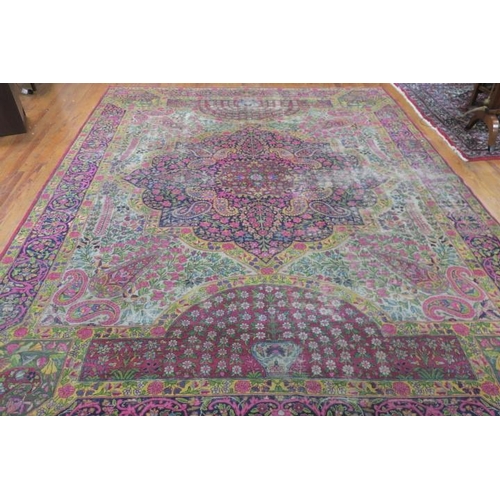 161 - AN ORIENTAL WOOL RUG the multicoloured ground with central panel filled with stylised flowerheads an... 