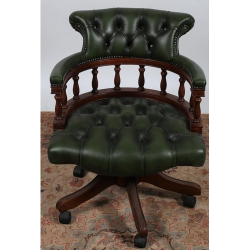 26 - A STAINED WOOD AND UPHOLSTERED SWIVEL LIBRARY CHAIR with deep buttoned upholstered back and seat wit... 