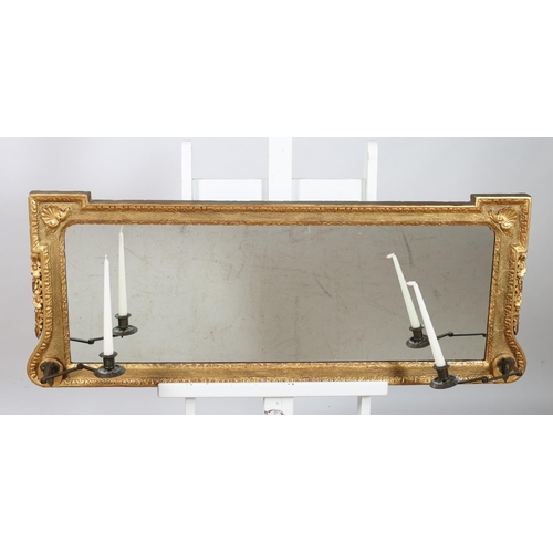 512 - A 19TH CENTURY GILTWOOD AND GESSO OVERMANTLE MIRROR of rectangular outline the shaped plate within a... 