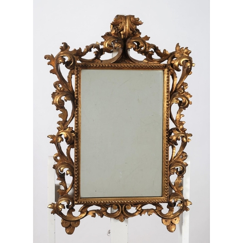 537 - A 19TH CENTURY CONTINENTAL CARVED GILTWOOD MIRROR the rectangular plate within a beadwork and foliat... 