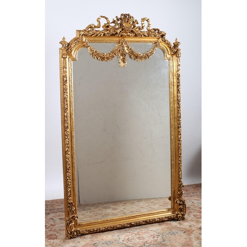 538 - A CONTINENTAL GILT FRAME MIRROR the rectangular shaped bevelled glass plate within a foliate and flo... 