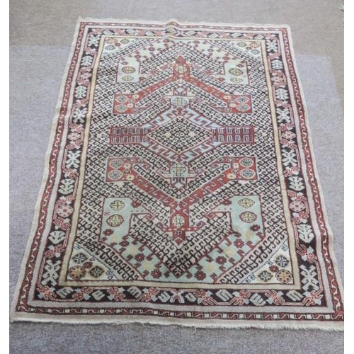 548 - A MELAS WOOL RUG the multicoloured ground with central panel filled with palmets, hooks, and stylise... 