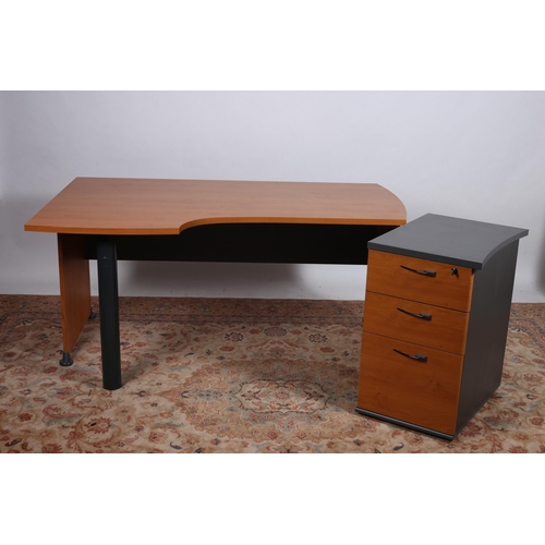 703 - A MODERN TEAK VENEER AND TUBULAR DESK the shaped top raised on cylindrical supports with end support... 