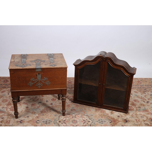 719 - AN OAK WALL MOUNTED CABINET the shaped cornice above a pair of glazed doors on moulded base 
69cm (h... 