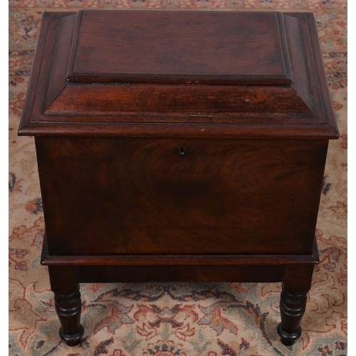 83 - A 19TH CENTURY MAHOGANY CELLARETTE the hinged lid containing compartments on ring turned tapering le... 