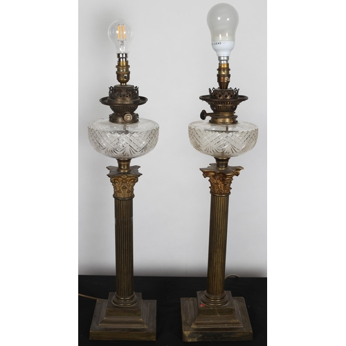 98 - A PAIR OF 19TH CENTURY BRASS OIL LAMPS each with a cut glass reservoir above a reeded column with Co... 