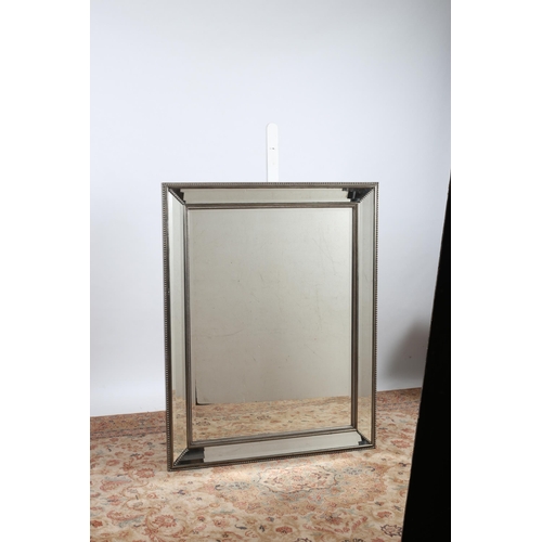 711 - A CONTINENTAL SILVER FRAME MIRROR the rectangular bevelled glass plate within a beadwork slip with b... 