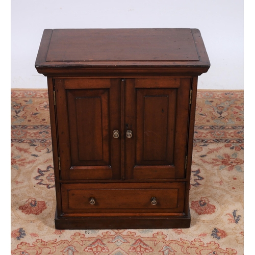 40 - AN EDWARDIAN MAHOGANY MINIATURE CABINET of rectangular outline the shaped top above a pair of panel ... 