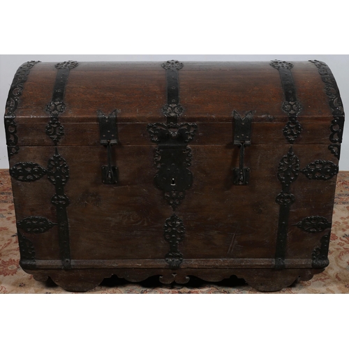 61 - A 19TH CENTURY OAK AND STEEL BOUND TRUNK of rectangular domed form the hinged lid with steel carryin... 