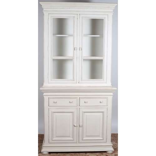 67 - A WHITE PAINTED DRESSER the moulded cornice above a pair of glazed doors containing shelves the base... 