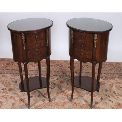 82 - A PAIR OF CONTINENTAL KINGWOOD AND GILT BRASS MOUNTED TABLES each of oval outline the shaped tops wi... 