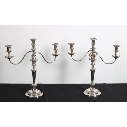 100 - A PAIR OF 19TH CENTURY SILVER PLATED ON COPPER THREE BRANCH CANDELBRA each with reeded scroll arms a... 