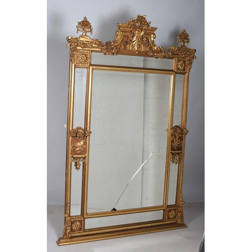 171 - A CONTINENTAL GILT FRAME COMPARTMENTED OVERMANTLE MIRROR the rectangular bevelled glass plate within... 