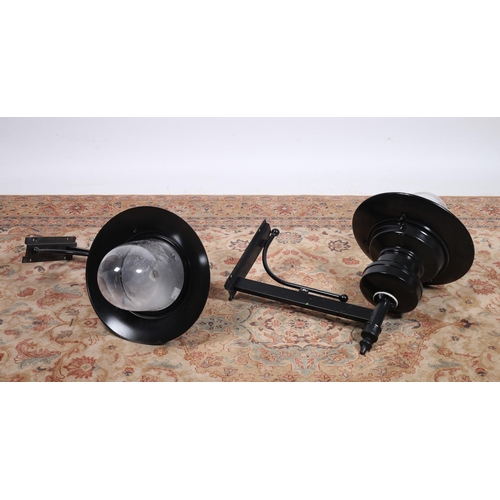 184 - A PAIR OF WROUGHT IRON WALL MOUNTED OUTSIDE LIGHTS each with a tubular arm and backplate with dome s... 