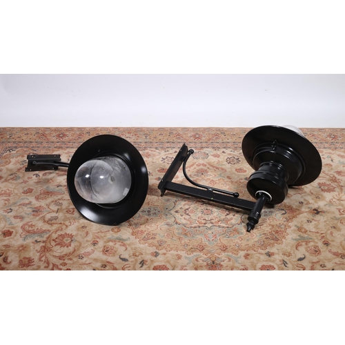 185 - A PAIR OF WROUGHT IRON WALL MOUNTED OUTSIDE LIGHTS each with a tubular arm and backplate with dome s... 