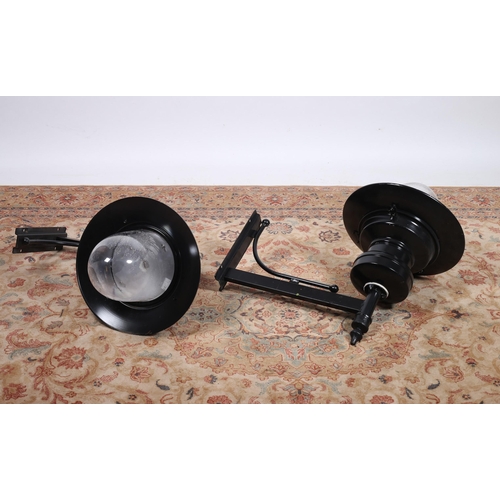 186 - A PAIR OF WROUGHT IRON WALL MOUNTED OUTSIDE LIGHTS each with a tubular arm and backplate with dome s... 