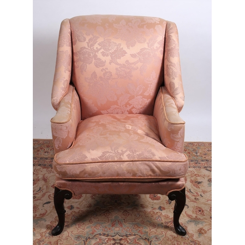 246 - A GEORGIAN DESIGN MAHOGANY AND UPHOLSTERED WING CHAIR the rectangular shaped back with scroll over a... 