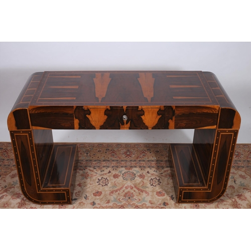 252 - AN ART DECO DESIGN ROSEWOOD DESK of rectangular outline the shaped top with rounded ends raised on L... 