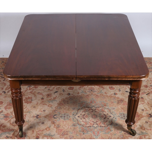 258 - A REGENCY MAHOGANY DRAW LEAF DINING TABLE of rectangular outline with rounded ends and two loose lea... 