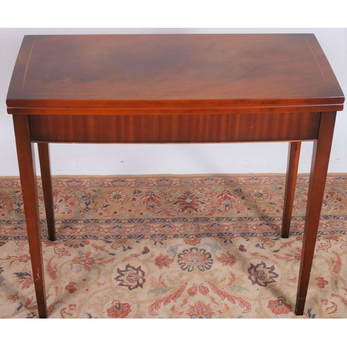 260 - A SHERATON DESIGN MAHOGANY AND SATINWOOD INLAID FOLDOVER SUPPER TABLE of rectangular bowed outline t... 