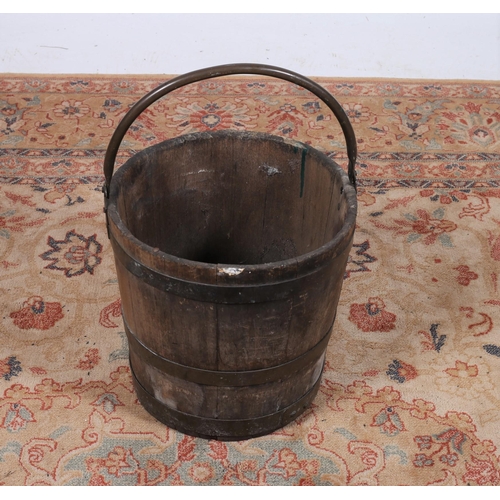 303 - A VINTAGE OAK AND BRASS BOUND SWING HANDLE PAIL of circular tapering form  30cm (h) x 31cm (d)