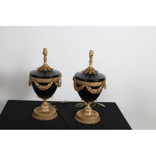 317 - A PAIR OF CONTINENTAL GILT BRASS AND TOLLWARE TABLE LAMPS each of urn form hung with floral festoons... 