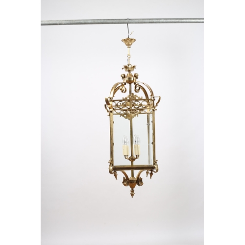 373 - A GILT BRASS FOUR LIGHT LANTERN of square form with pierced frieze and scroll arms with foliate deco... 