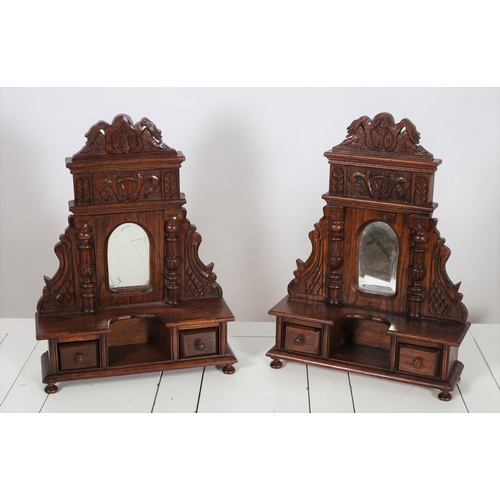 103 - A PAIR OF MINIATURE CARVED OAK DRESSING TABLES each with a rectangular arched mirror between fluted ... 