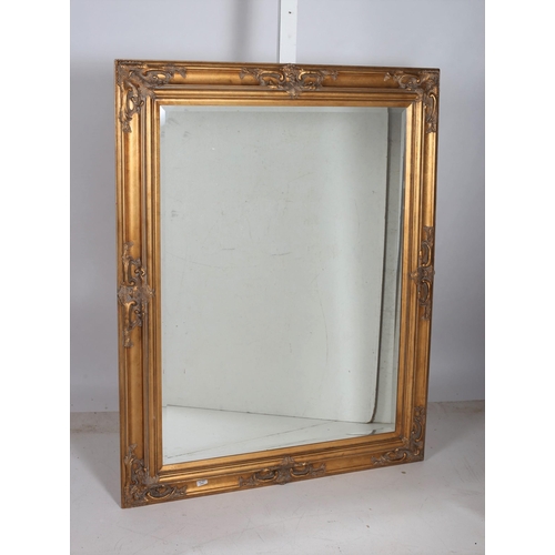 732 - A CONTINENTAL GILT FRAME MIRROR the rectangular bevelled glass plate within a moulded frame with fol... 