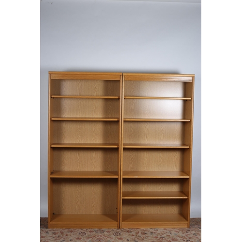 817 - A PAIR OF BEECHWOOD OPEN FRONT SHELVES the moulded cornice above six open shelves, one containing fi... 