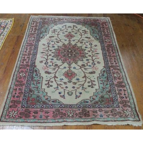 860 - A KASHAN WOOL RUG the beige and light pink ground with central panel filled with stylised flowerhead... 