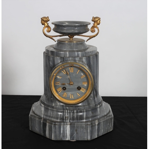 114 - A FRENCH GREY MARBLE CLOCK the circular fluted case surmounted by an urn flanked by figural mask han... 