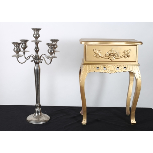 117 - A LARGE WHITE METAL FIVE BRANCH CANDELABRA with scroll arms above a baluster column on a circular sp... 