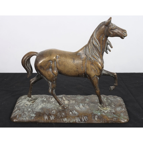 136 - A BRASS FIGURE modelled as a horse shown standing on a naturalistic base 
27cm (h) x 35cm (w) x 15cm... 