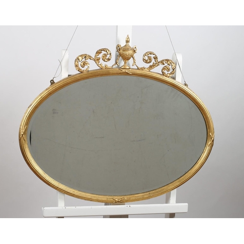 157 - A 19TH CENTURY ADAM DESIGN GILT FRAME MIRROR the oval bevelled glass plate within a reeded frame wit... 