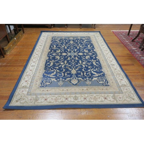 178 - A WOOL RUG the blue and beige ground with central panel with foliate decoration within a conforming ... 