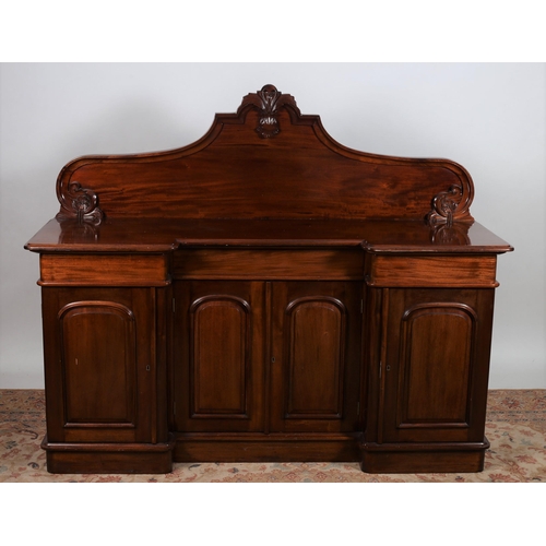 189 - A VICTORIAN DESIGN MAHOGANY BREAKFRONT SIDEBOARD the shaped top with carved and moulded back above t... 