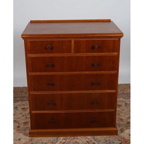 206 - A CHERRYWOOD CHEST of rectangular outline the shaped top above two short and four long drawers on pl... 