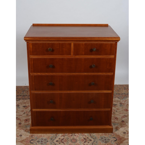 207 - A CHERRYWOOD CHEST of rectangular outline the shaped top with moulded back above two short and four ... 