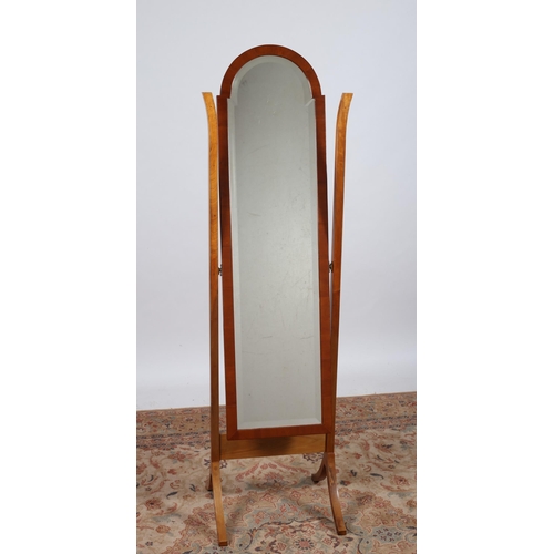 211 - A CHERRYWOOD CHEVAL MIRROR the rectangular arched frame containing a bevelled glass mirror raised on... 