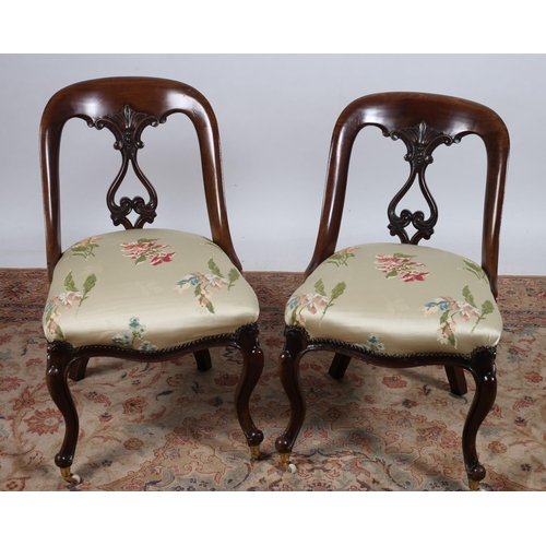 212 - A PAIR OF 19TH CENTURY MAHOGANY AND UPHOLSTERED SIDE CHAIRS each with a curved back and pierced vert... 