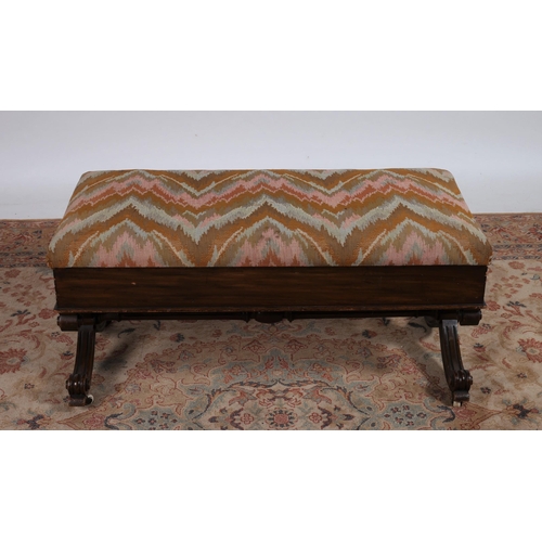 215 - AN EDWARDIAN WALNUT AND UPHOLSTERED STOOL of rectangular outline the hinged seat above a moulded apr... 