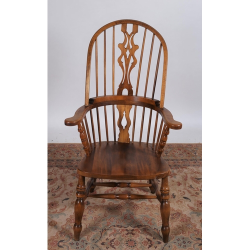 223 - AN ASH WOOD WINDSOR CHAIR the curved top rail above a pierced vertical splat with spindle uprights a... 