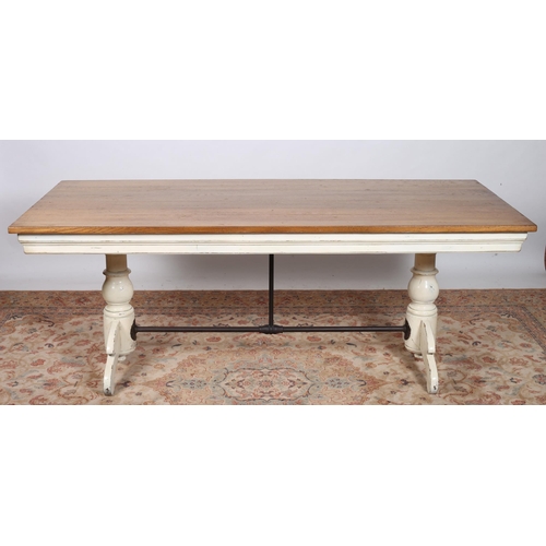 238 - A VINTAGE OAK AND PAINTED REFECTORY TABLE of rectangular outline the shaped top above a white painte... 