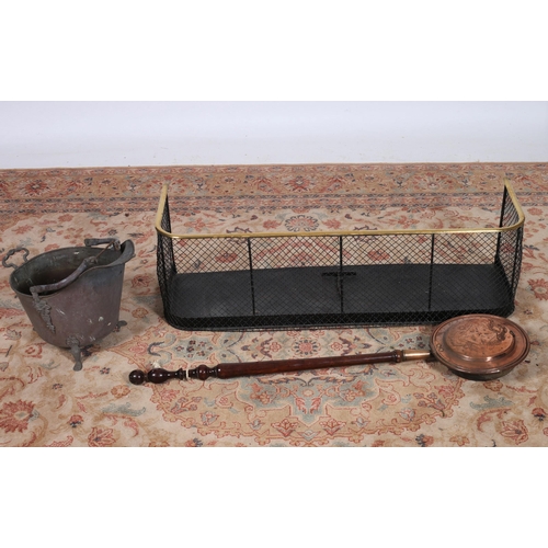 272 - A 19TH CENTURY BRASS AND MESH FENDER together with a copper bed warmer and a copper coal helmet (3)