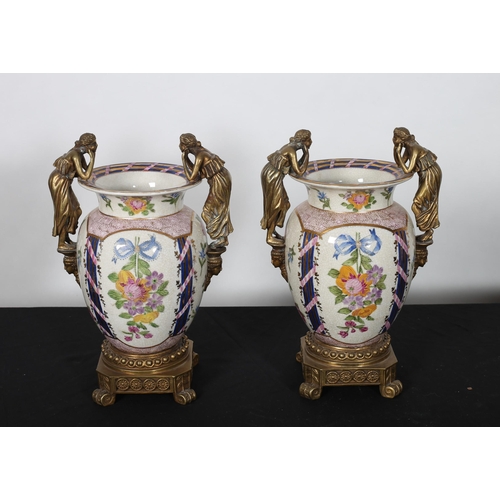 290 - A PAIR OF CONTINENTAL GLAZED CHINA AND GILT BRASS VASES each of bulbous form the white ground decora... 